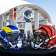 The helmets of the Super Bowl participants Los Angeles Rams (l) and Cinncinati Bengals stand on a table in front of the Vince Lombardy Trophy, which the winner receives. NFL boss Roger Goodell gives a press conference before the Super Bowl.